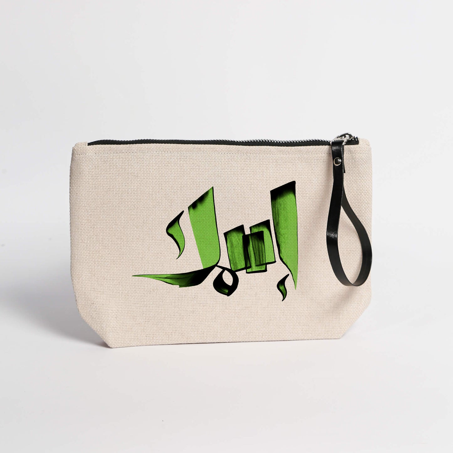 A beige carryall pouch with a green Arabic calligraphy print and a black zipper in isim style